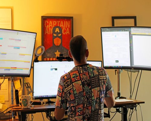 Professional setting up an ergonomic workstation with adequate distance from monitor